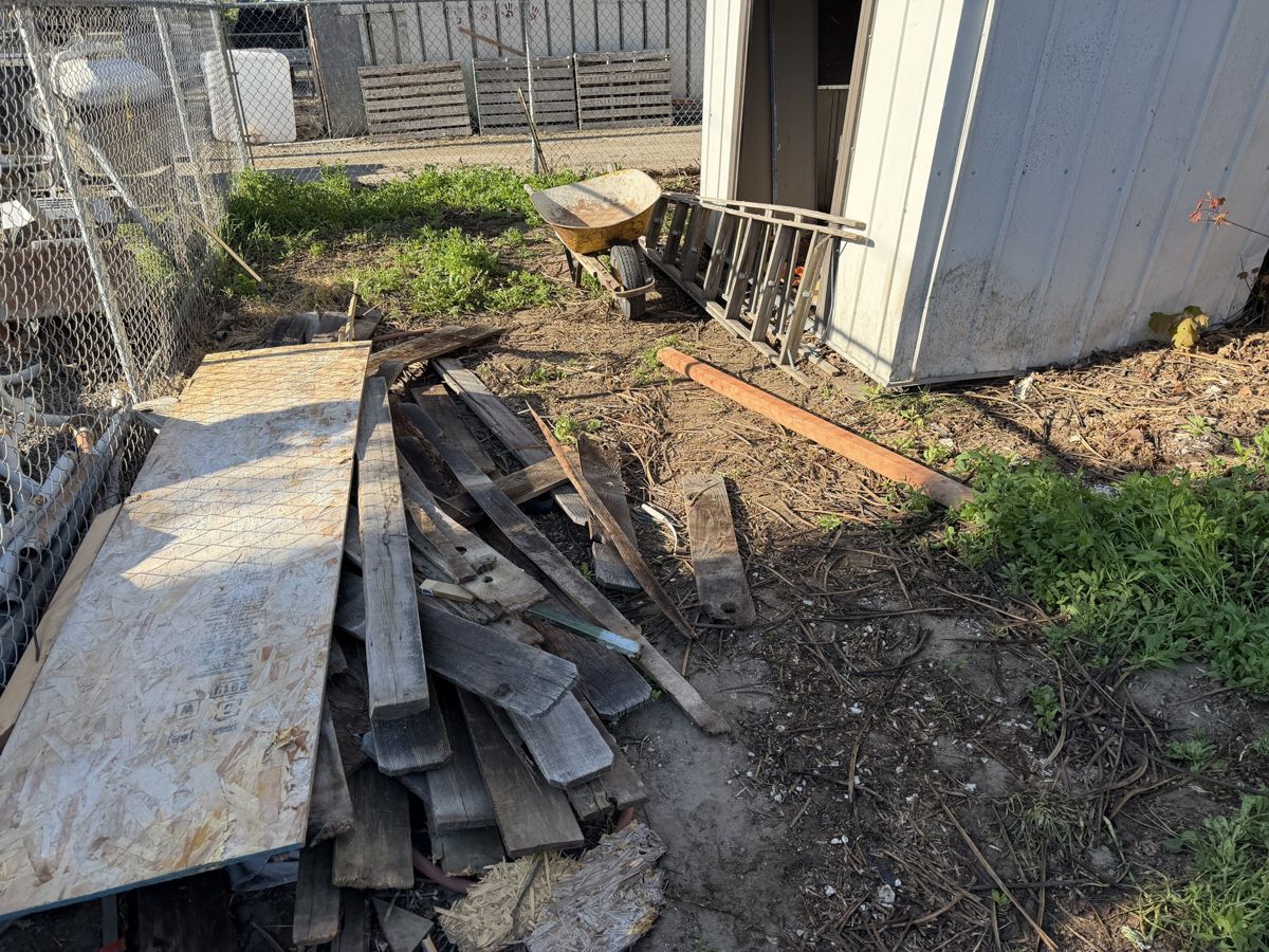 Scrap lumber and debris pile before removal