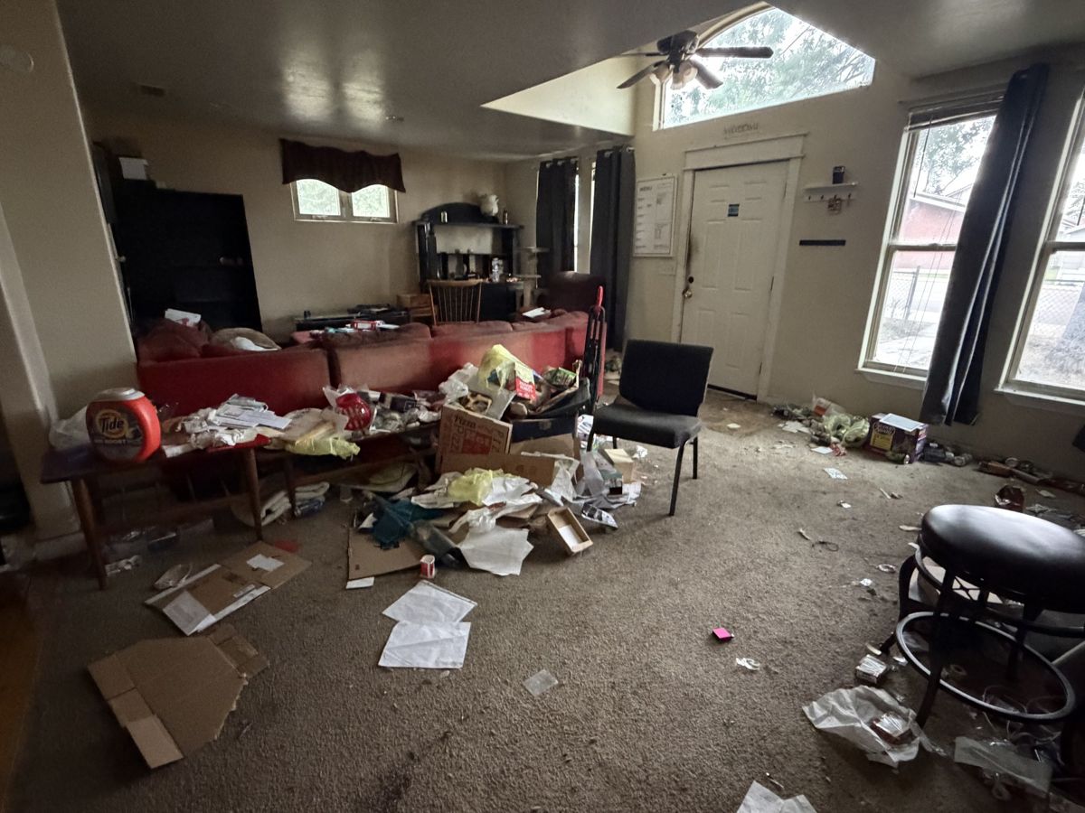 Living room full of items before a cleanout
